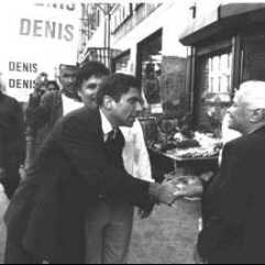 Candidate Denis shaking hands with elderly voter