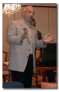 Councilman Phil Reed speaking before Community Board # 11's December meeting about the museums proposed move.