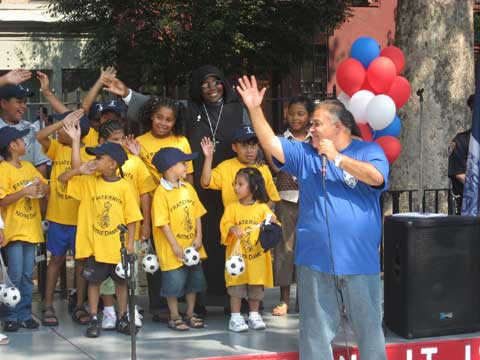 Neighborhood children pledging with Reverend Gilberto Lopez, clergy liaison for the 23rd Precinct, on September 8, 2007 to continue the legacy of the fallen heroes of 9-11 by living a positive life and making a difference in their community.