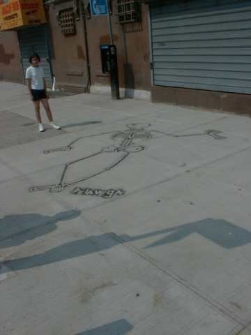 Picture of a skelton done by James De La Vega on the sidewalk