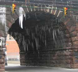 Photo of icycles sticking out from underneath the train tunnel at Park Avenue and East 106 Street. Taken on January 19, 2005.