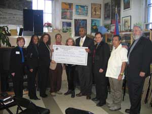 La Casa De La Herencia Cultural Puertorriquena receives a check for 225K from Mr. Kenneth Knuckles, President and CEO of the Upper Manhattan Empowerment Zone.