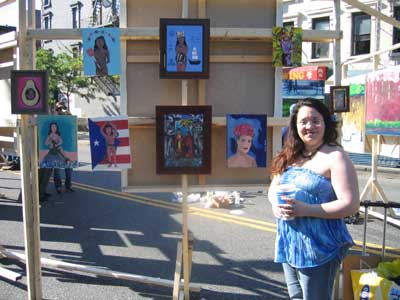New upcoming artist, Linda Alicea poses next to her art