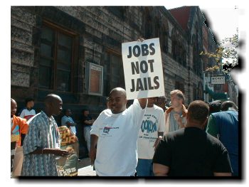 Picture of participant holding up sign which read "Jobs not Jails"