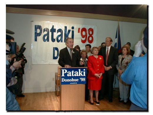 Picture of Fomer Congressman Herman Badillo, State Senator Olga Mendez and Governor George Pataki standing before the crowd